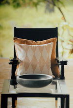 Load image into Gallery viewer, Terracotta coloured block printed cushion cover sitting in front of a cotton hand woven terracotta sham