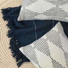 Load image into Gallery viewer, Two hand blocked charcoal diamond design cushion covers on a navy throw balnket
