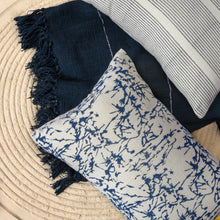 Load image into Gallery viewer, Hand blocked cotton cushion cover in blue placed on a hand woven throw
