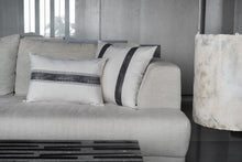 Load image into Gallery viewer, Charcoal double sided striped block print design on an ivory cotton base fabric sitting behind the charcoal lumbar cushion cover on a couch
